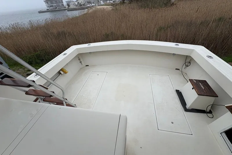 Slide: The Image of 1988 Viking 41 Convertible boat on stands, parked near a black truck. - 6