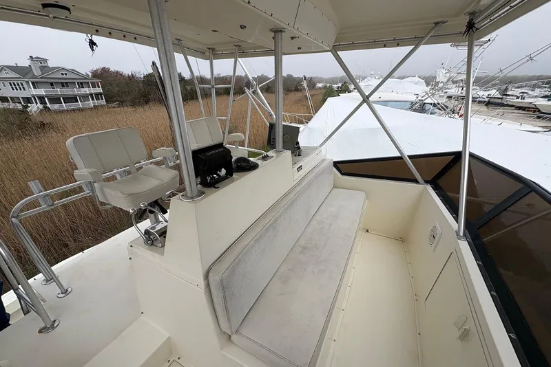 Slide: The Image of 1988 Viking 41 Convertible boat on land, surrounded by other boats and a truck. - 9