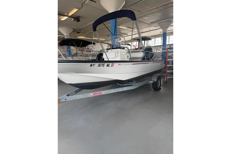 The Image of 2015 Boston Whaler 170 Montauk boat on trailer in indoor storage. - 0