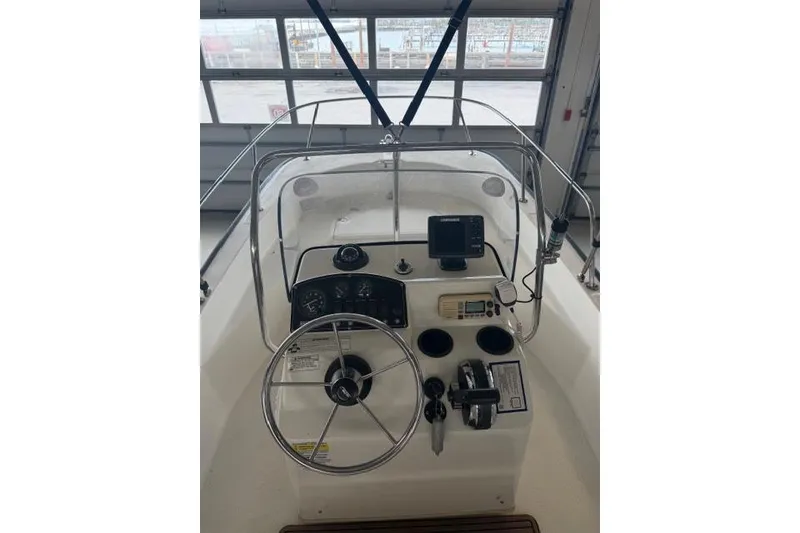Slide: The Image of 2015 Boston Whaler 170 Montauk boat console with steering wheel and navigation equipment. - 10
