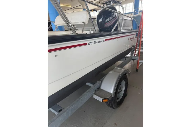 Slide: The Image of 2015 Boston Whaler 170 Montauk boat on trailer in indoor storage. - 2