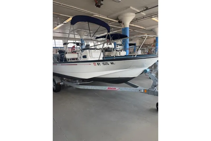 Slide: The Image of 2015 Boston Whaler 170 Montauk boat on trailer in indoor storage. - 3