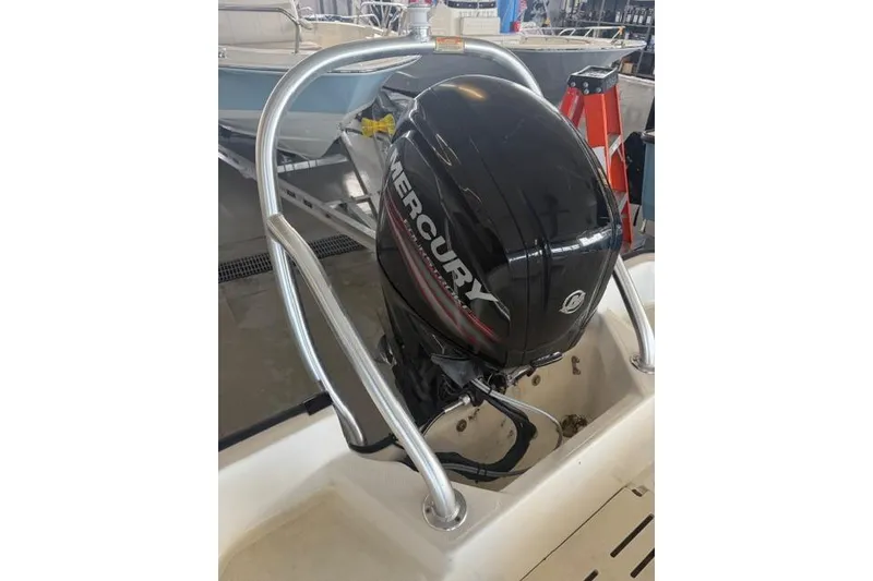 Slide: The Image of 2015 Boston Whaler 170 Montauk with Mercury outboard motor in a showroom. - 4