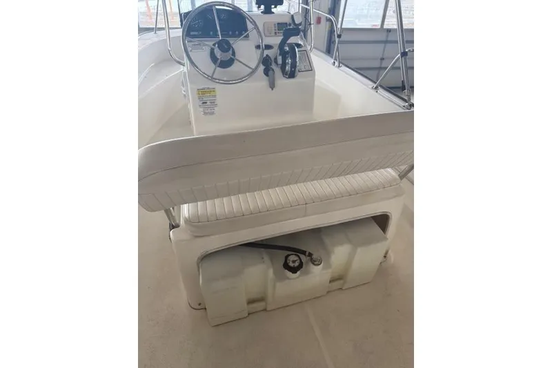 Slide: The Image of 2015 Boston Whaler 170 Montauk boat interior with steering console and seating. - 5