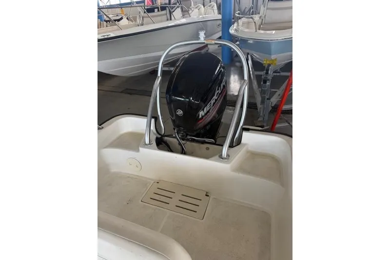 Slide: The Image of 2015 Boston Whaler 170 Montauk boat with Mercury outboard motor in showroom. - 6