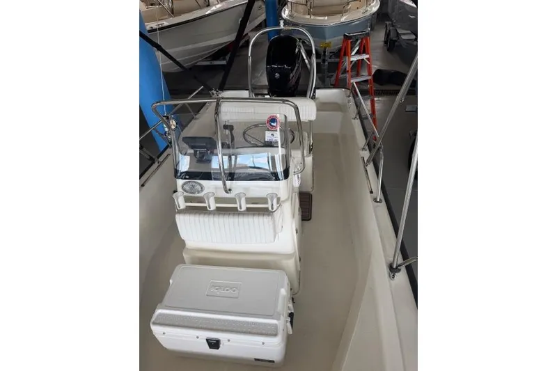 Slide: The Image of 2015 Boston Whaler 170 Montauk boat interior with console and cooler. - 7