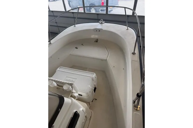 Slide: The Image of 2015 Boston Whaler 170 Montauk boat interior with seating and storage. - 9