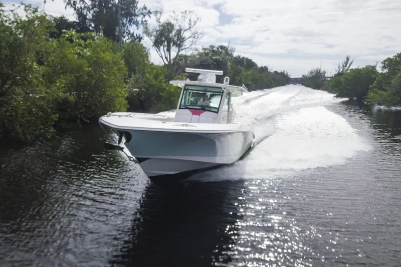 The Image of 2012 Boston Whaler 370 Outrage cruising swiftly on a scenic waterway. - 0
