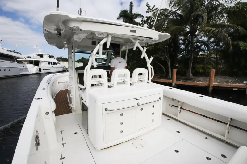 Slide: The Image of 2012 Boston Whaler 370 Outrage boat docked with palm trees. - 10