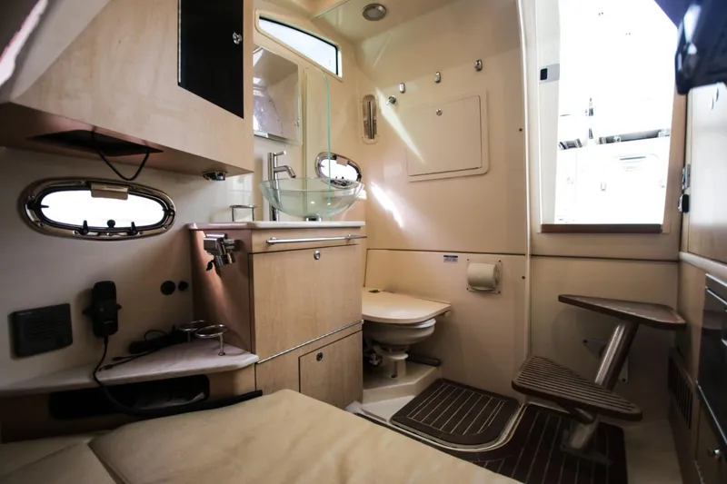 Slide: The Image of Interior of 2012 Boston Whaler 370 Outrage featuring bathroom and sink. - 13