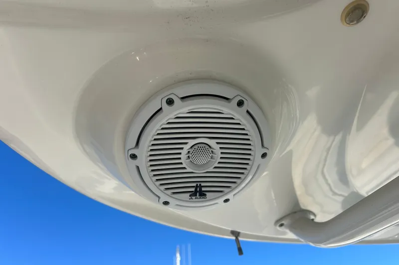 Slide: The Image of JL Audio speaker on 2012 Boston Whaler 370 Outrage boat, under clear blue sky. - 20