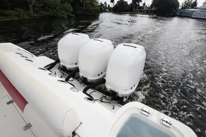 Slide: The Image of 2012 Boston Whaler 370 Outrage with triple outboard engines on the water. - 6