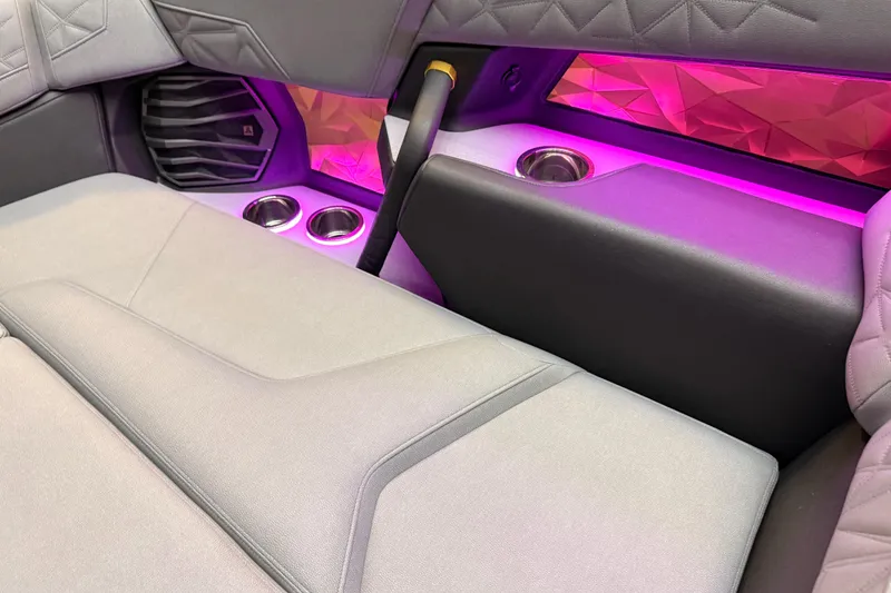 Slide: The Image of 2024 Nautique Super Air Nautique G25 Paragon interior with ambient lighting and cup holders. - 10