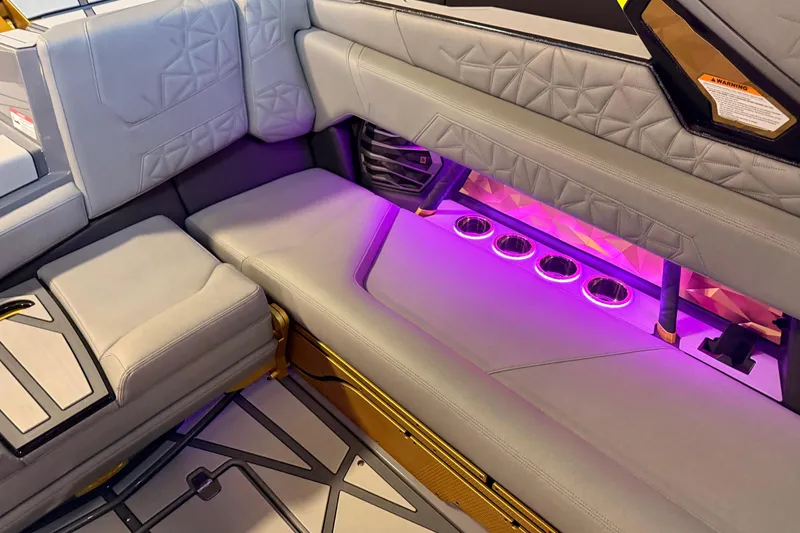 Slide: The Image of Luxurious interior of 2024 Nautique Super Air Nautique G25 Paragon with ambient purple lighting. - 16