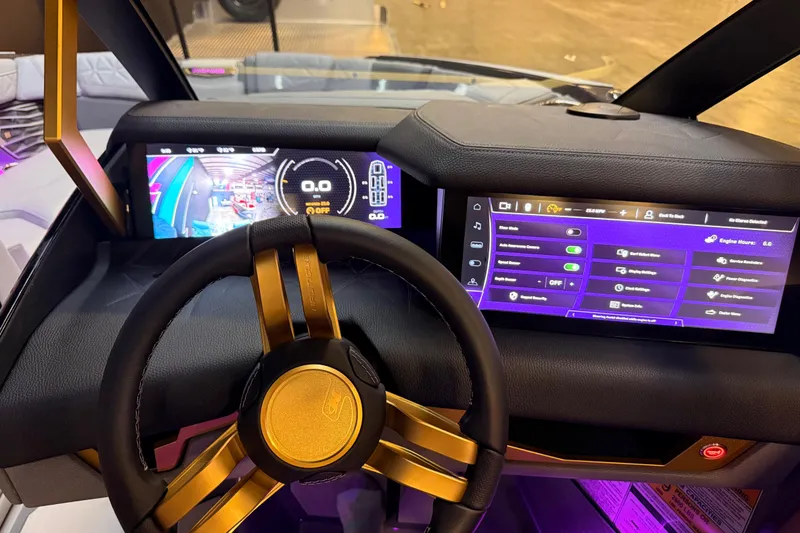 Slide: The Image of 2024 Nautique Super Air Nautique G25 Paragon dashboard with digital displays and gold-accented steering wheel. - 19
