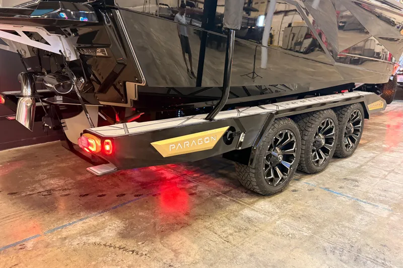 Slide: The Image of 2024 Nautique Super Air Nautique G25 Paragon on a triple-axle trailer with illuminated rear lights. - 4