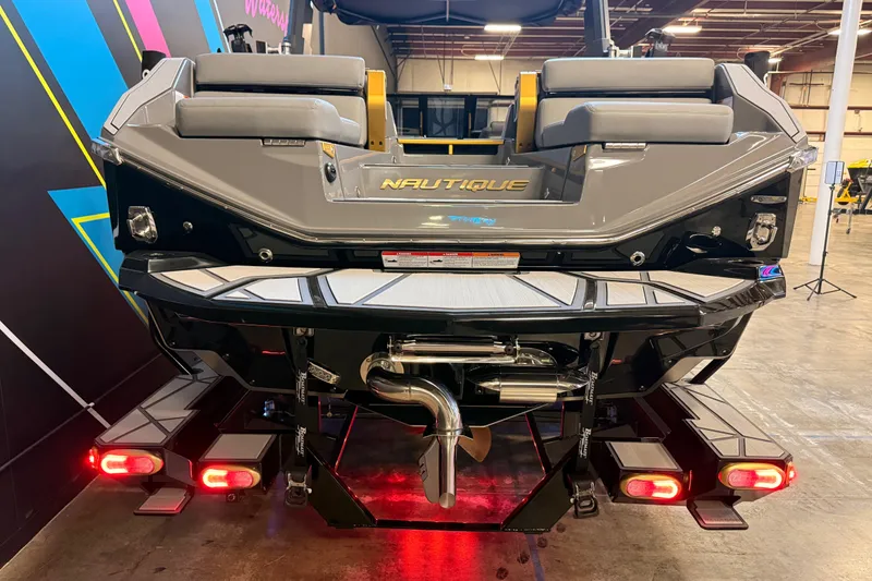 Slide: The Image of 2024 Nautique Super Air Nautique G25 Paragon rear view in showroom setting. - 6