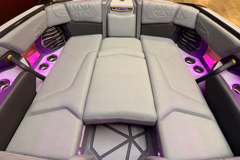 Slide: The Image of 2024 Nautique Super Air Nautique G25 Paragon interior with luxurious seating and ambient lighting. - 7