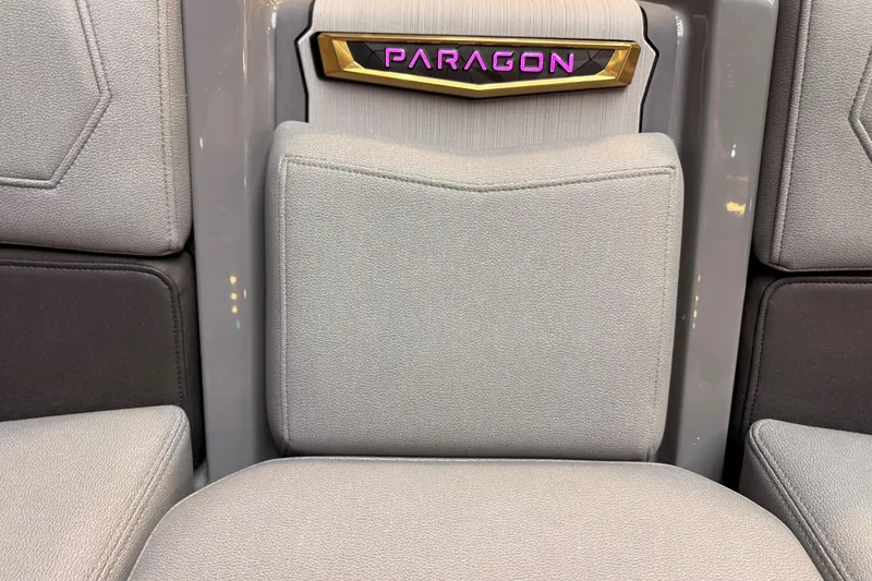 Slide: The Image of 2024 Nautique Super Air Nautique G25 Paragon interior with luxurious seating and Paragon emblem. - 8
