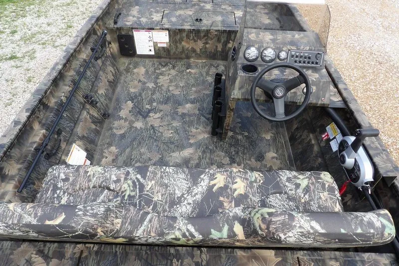 Slide: The Image of 2026 Crestliner 1860 Retriever SC boat interior with camouflage design and steering console. - 10