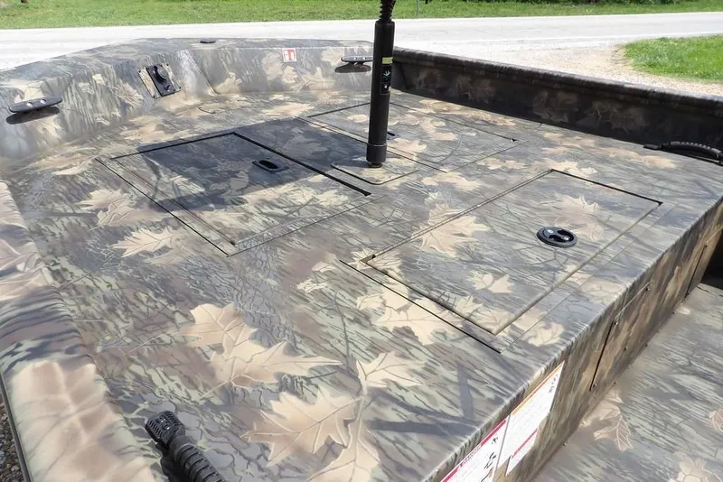 Slide: The Image of 2026 Crestliner 1860 Retriever SC boat with camouflage design and storage compartments. - 12