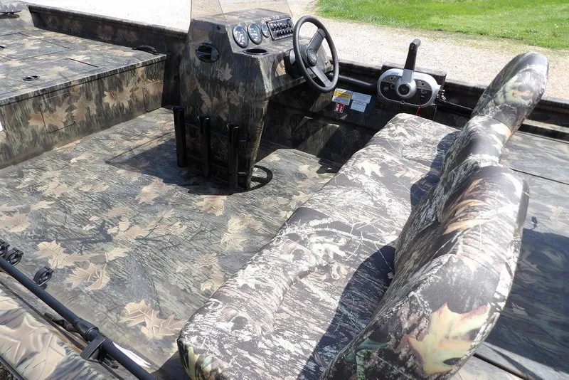 Slide: The Image of 2026 Crestliner 1860 Retriever SC boat interior with camouflage design and steering console. - 13