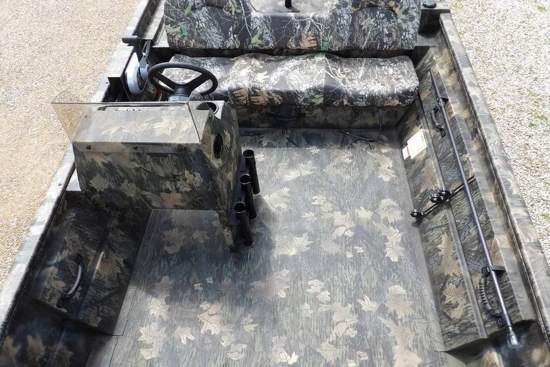 Slide: The Image of 2026 Crestliner 1860 Retriever SC boat interior with camouflage design and steering console. - 16