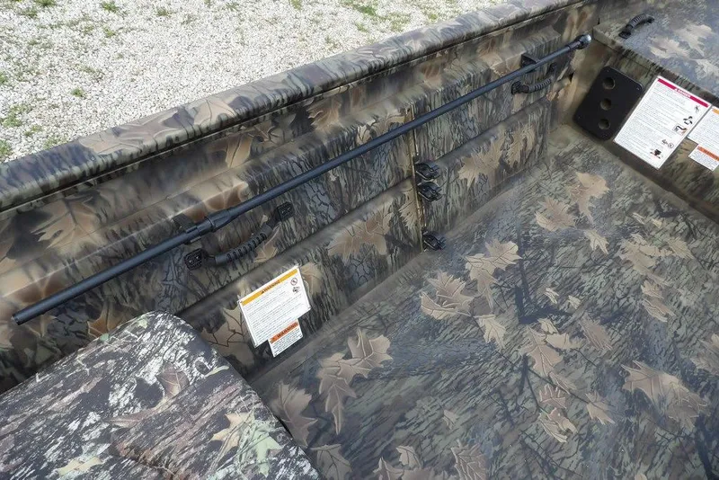 Slide: The Image of 2026 Crestliner 1860 Retriever SC boat interior with camouflage design and safety instructions. - 17