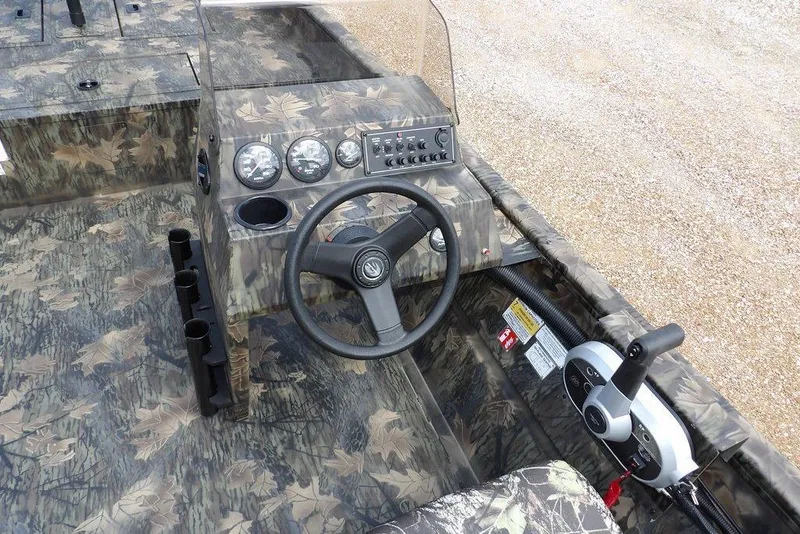 Slide: The Image of 2026 Crestliner 1860 Retriever SC boat interior with camouflage design and steering console. - 20