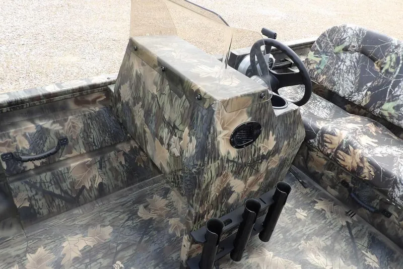 Slide: The Image of 2026 Crestliner 1860 Retriever SC boat interior with camouflage design and steering console. - 23