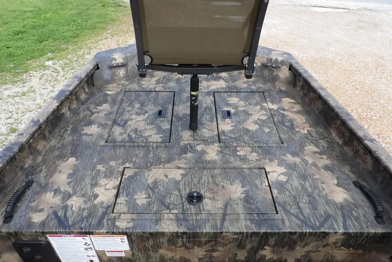 Slide: The Image of Camo-patterned deck of 2026 Crestliner 1860 Retriever SC boat with storage compartments. - 25