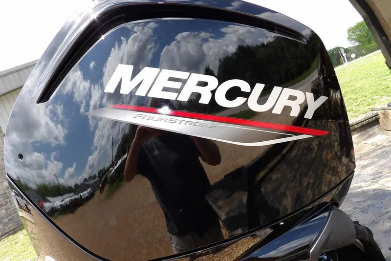 Slide: The Image of Mercury FourStroke engine on 2026 Crestliner 1860 Retriever SC, reflecting sky and surroundings. - 28