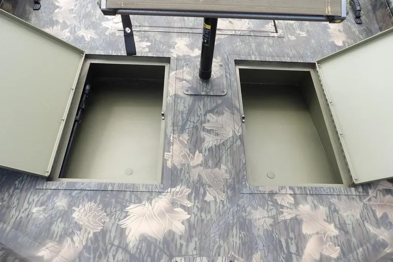 Slide: The Image of 2026 Crestliner 1860 Retriever SC boat with open storage compartments and camouflage design. - 30