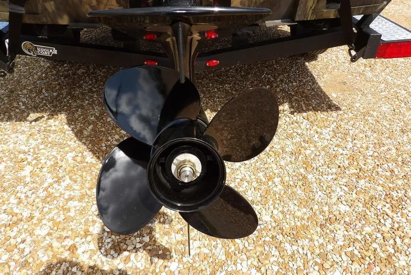 Slide: The Image of Propeller of 2026 Crestliner 1860 Retriever SC boat on gravel surface. - 32