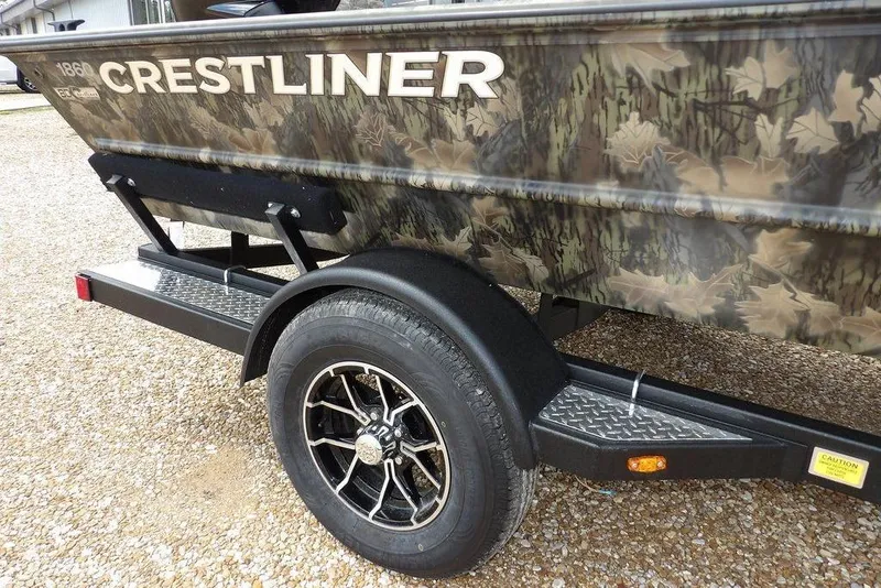 Slide: The Image of 2026 Crestliner 1860 Retriever SC boat with camouflage design on a trailer. - 33