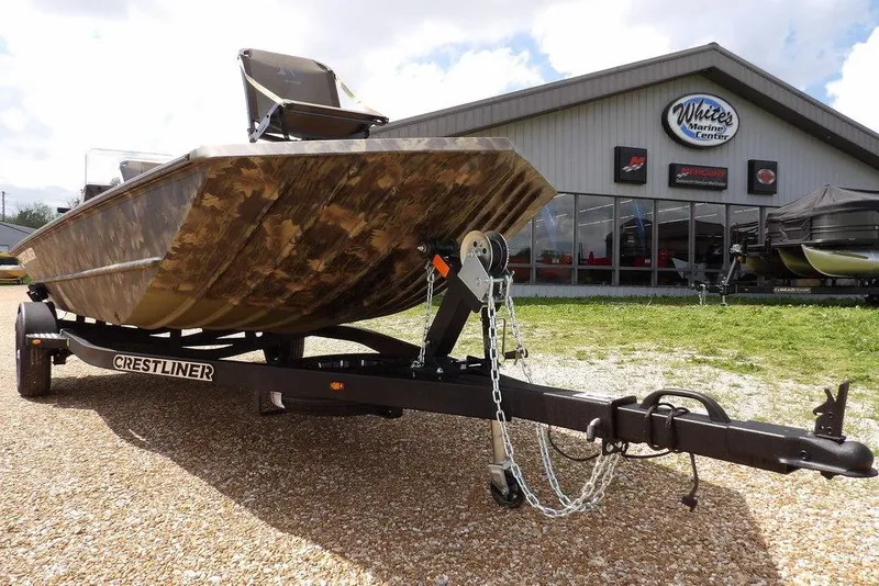 Slide: The Image of 2026 Crestliner 1860 Retriever SC boat on trailer outside marine center. - 34