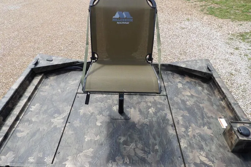 Slide: The Image of 2026 Crestliner 1860 Retriever SC boat with camo pattern and mounted seat. - 35