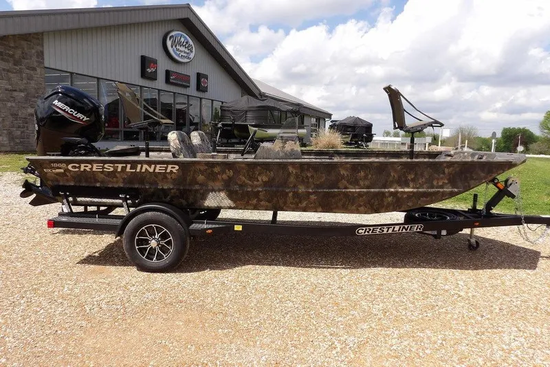 Slide: The Image of 2026 Crestliner 1860 Retriever SC boat on trailer, parked outside dealership. - 4