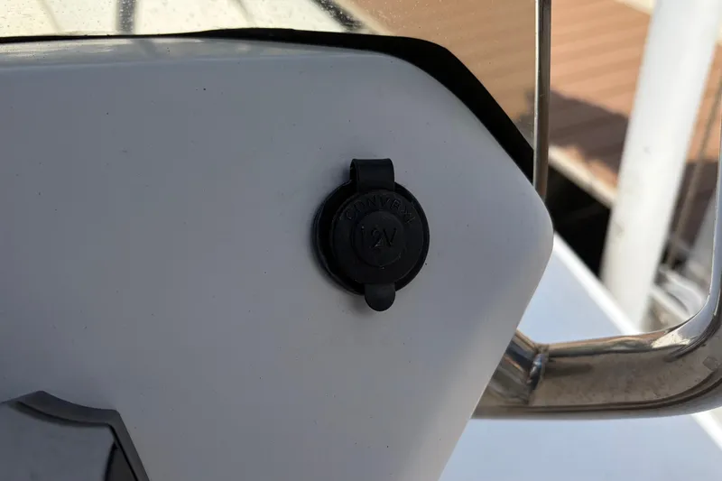 Slide: The Image of 12V power outlet on 2021 Zodiac N-ZO 680 boat console. - 13