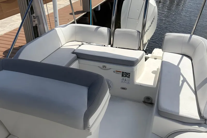 Slide: The Image of 2021 Zodiac N-ZO 680 boat interior with white cushioned seating and Mercury engine. - 18