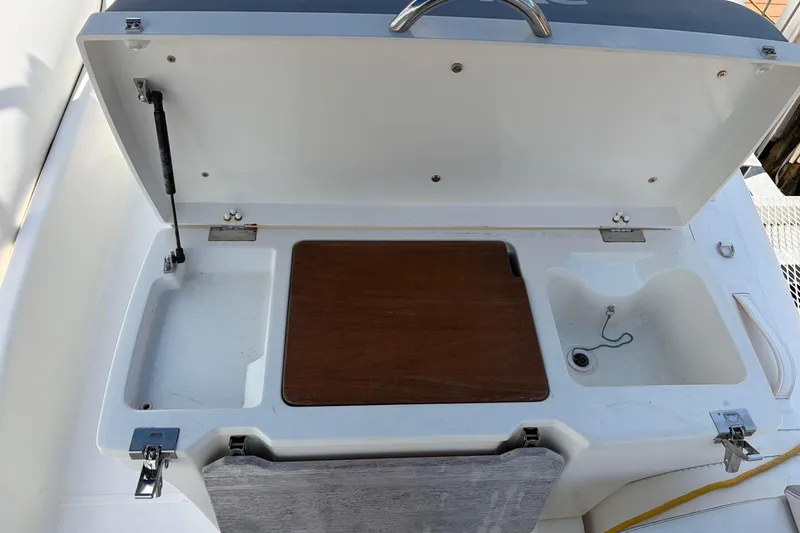 Slide: The Image of 2021 Zodiac N-ZO 680 boat sink and storage area with wooden cover. - 20