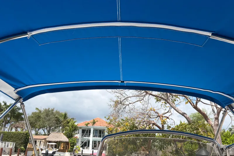 Slide: The Image of Blue canopy of 2021 Zodiac N-ZO 680 boat with scenic background. - 23