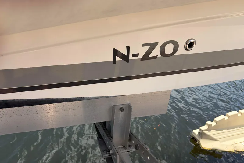 Slide: The Image of 2021 Zodiac N-ZO 680 boat on lift, docked by water. - 30