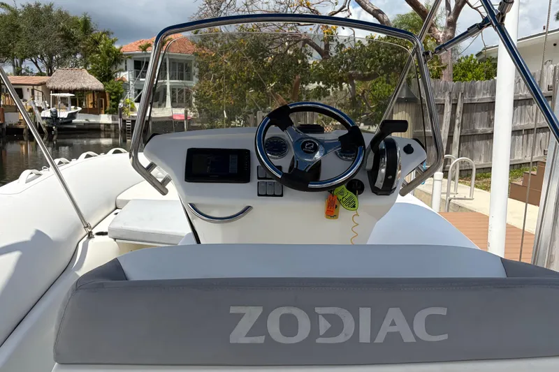 Slide: The Image of 2021 Zodiac N-ZO 680 boat cockpit with steering wheel and controls. - 7