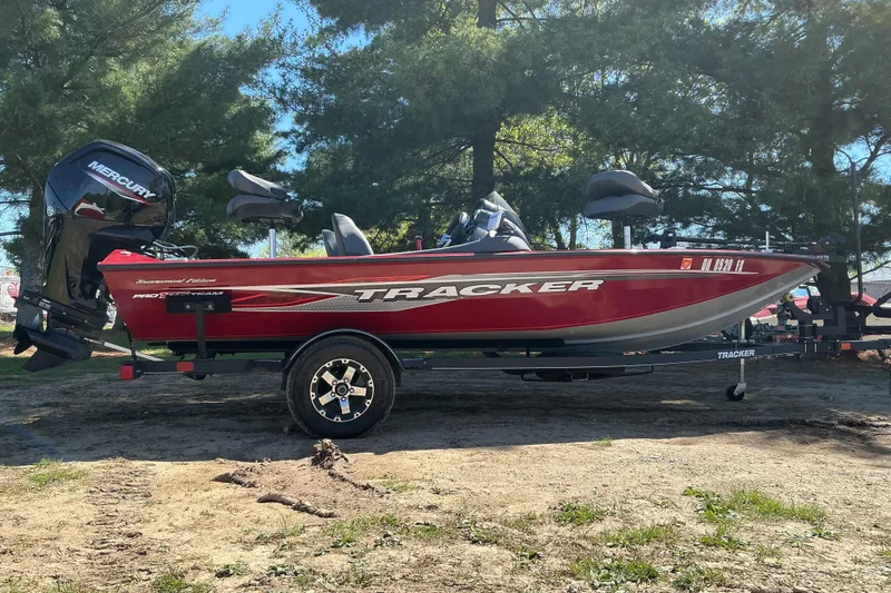 The Image of 2020 Tracker Pro Team 175 TXW Tournament Edition boat on trailer, parked outdoors. - 1