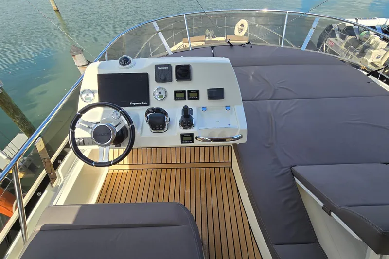 Slide: The Image of Cockpit of 2018 Prestige 460 yacht with modern controls and teak flooring. - 14