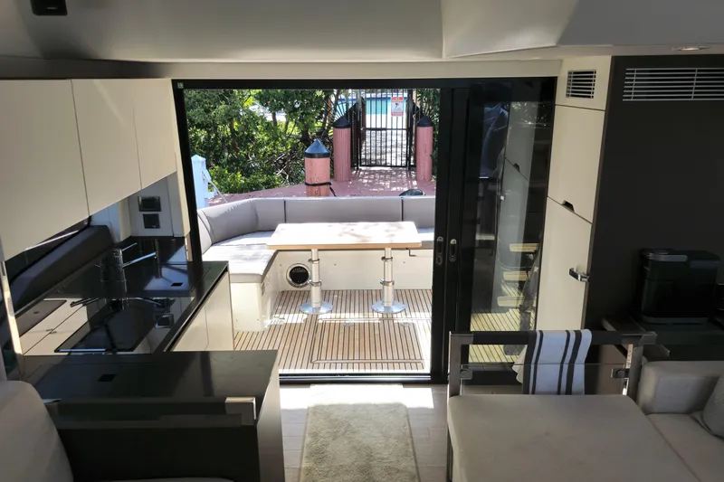 Slide: The Image of Interior of 2018 Prestige 460 yacht with modern kitchen and outdoor seating area. - 20