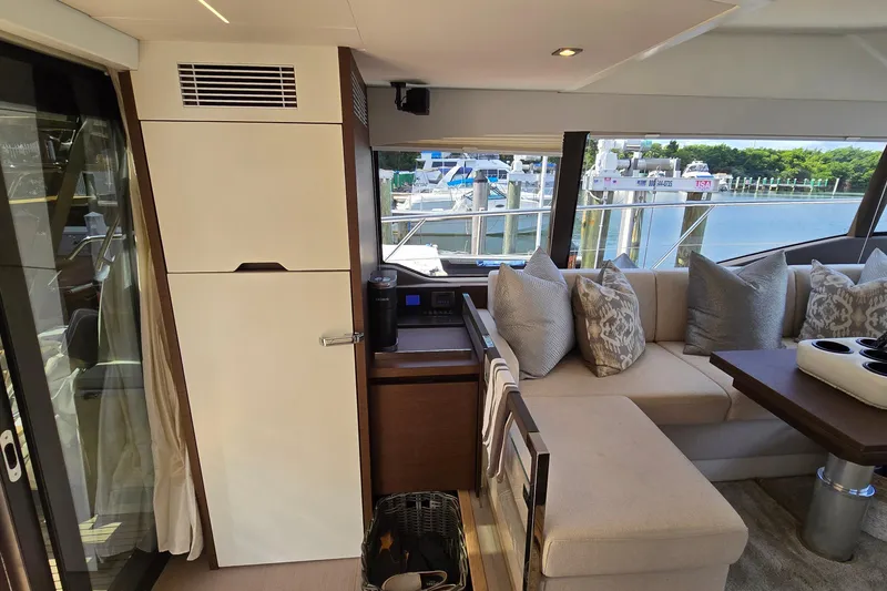 Slide: The Image of Luxurious interior of a 2018 Prestige 460 yacht with plush seating and marina view. - 22