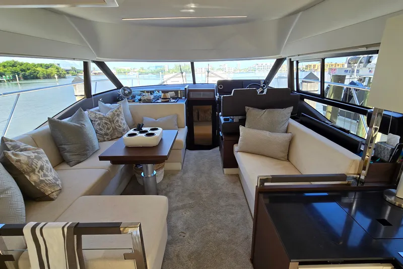 Slide: The Image of Luxurious interior of a 2018 Prestige 460 yacht with elegant seating and scenic views. - 23