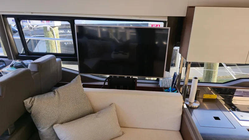 Slide: The Image of Interior of 2018 Prestige 460 yacht with TV, sofa, and modern decor. - 26